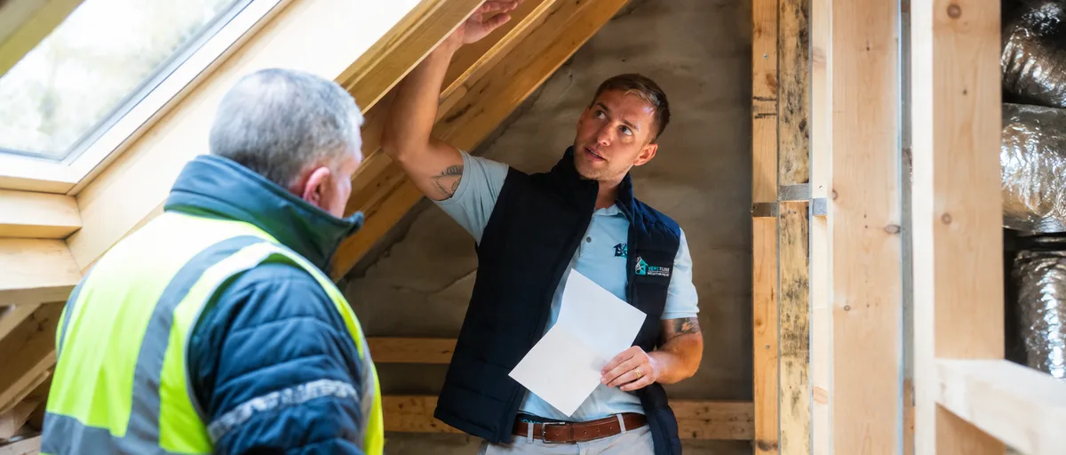 VentSolve technicians installing ventilation ducting in an attic