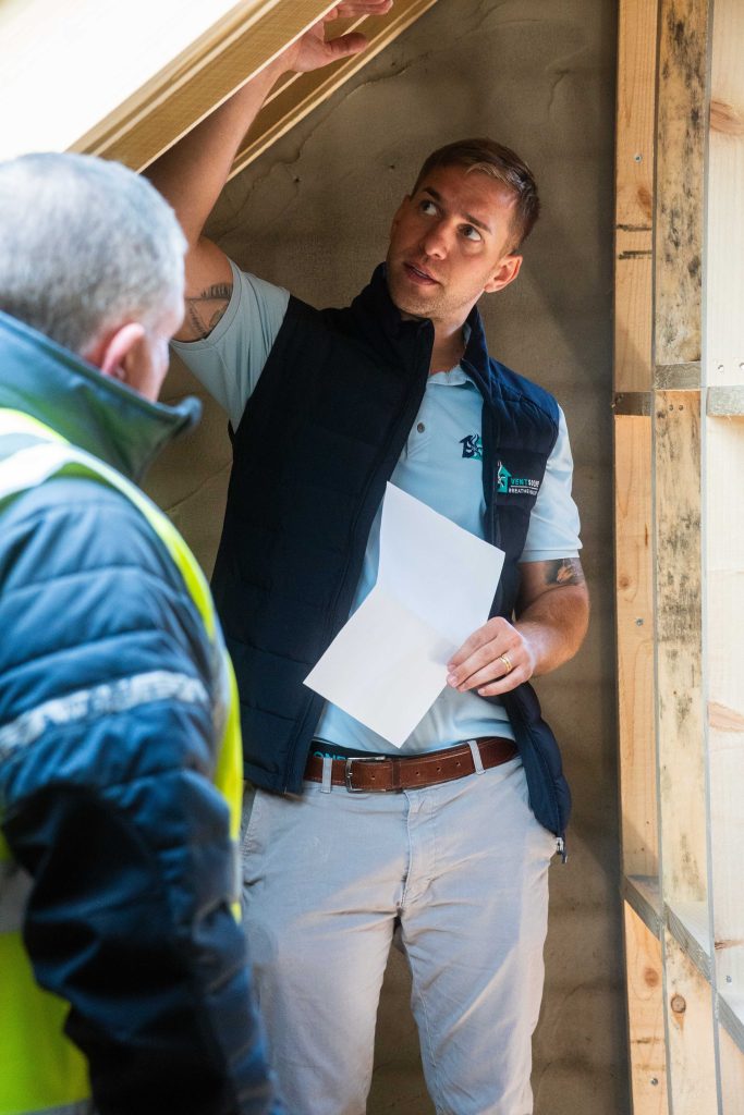 VentSolve surveyor checking an attic hatch during a home visit