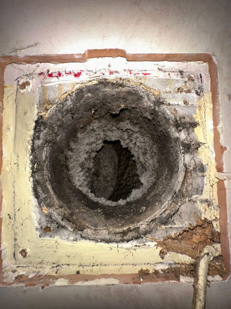 Bathroom Extractor Fan Replacement in Dublin: Signs, Process and Cost 2 Bathroom extract duct opening choked with dust and lint behind an old fan